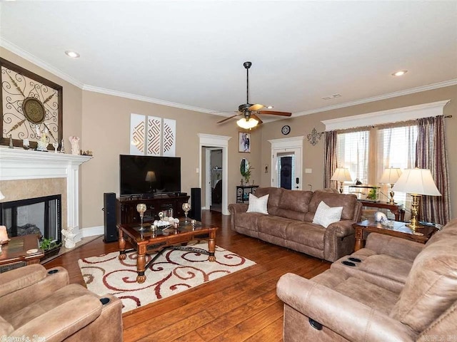 living room featuring hardwood / wood-style floors, ceiling fan, and ornamental molding