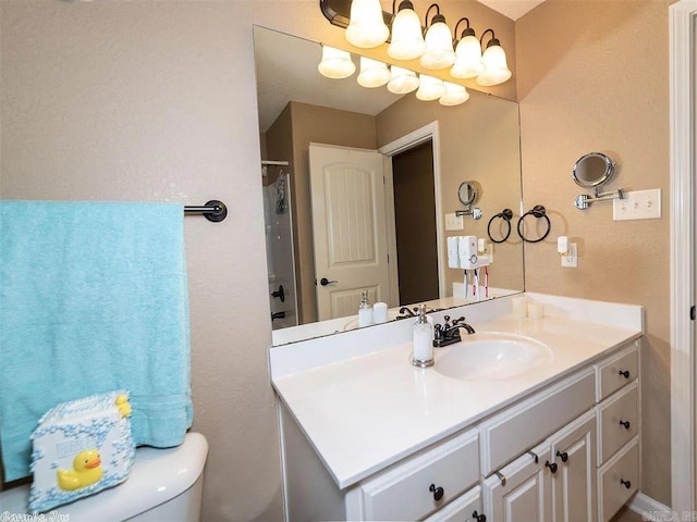 bathroom featuring a shower with curtain, vanity, and toilet