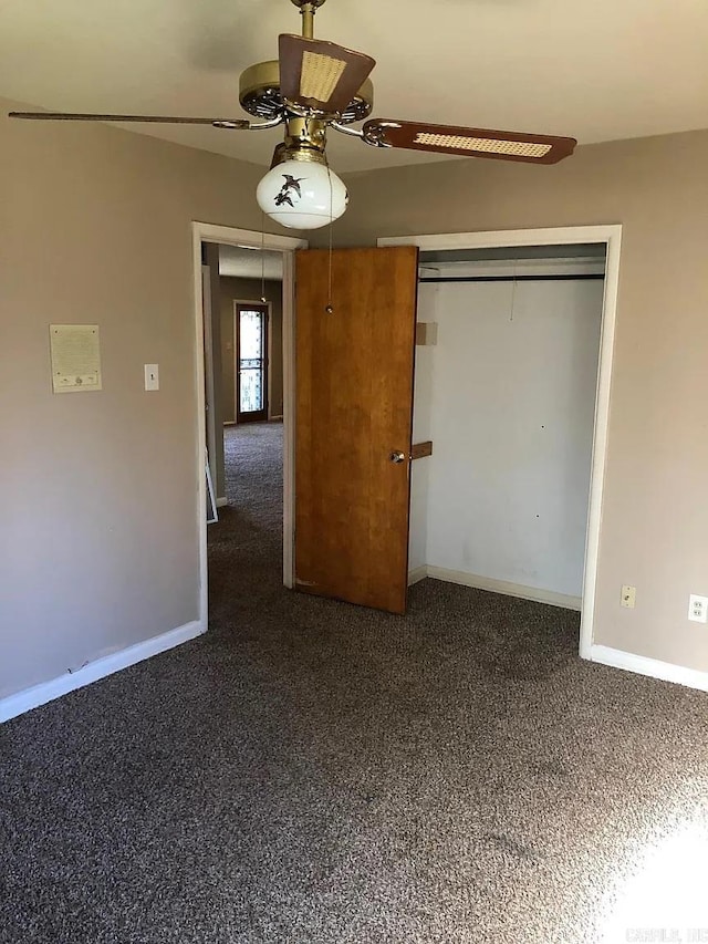 unfurnished bedroom featuring a closet, ceiling fan, and dark carpet