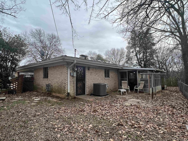 back of house featuring cooling unit and a sunroom