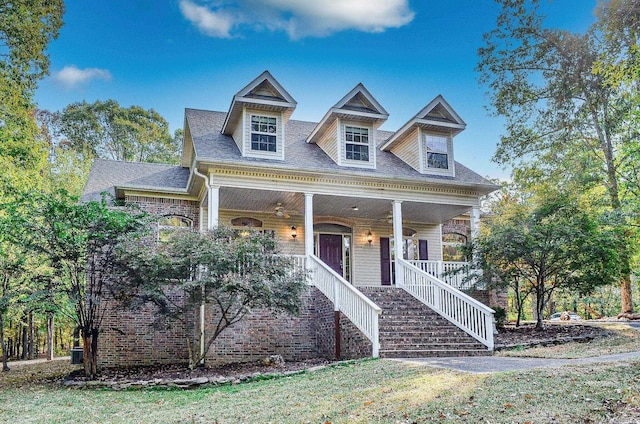 cape cod house featuring covered porch