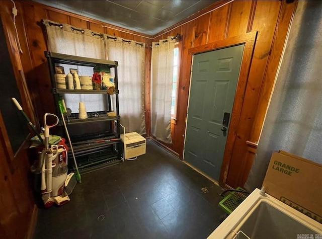 foyer entrance featuring wooden walls