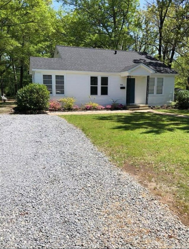 ranch-style home with a front lawn