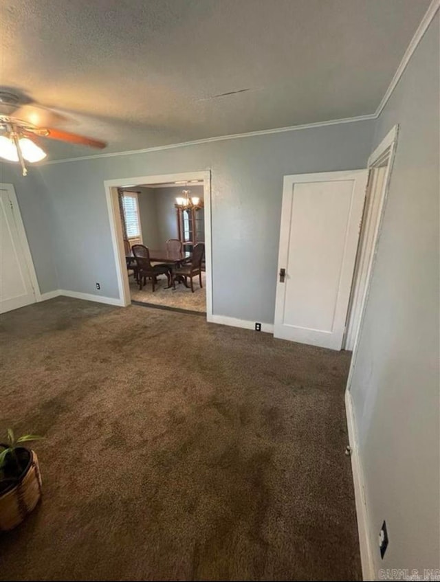 carpeted empty room with crown molding, a textured ceiling, and ceiling fan