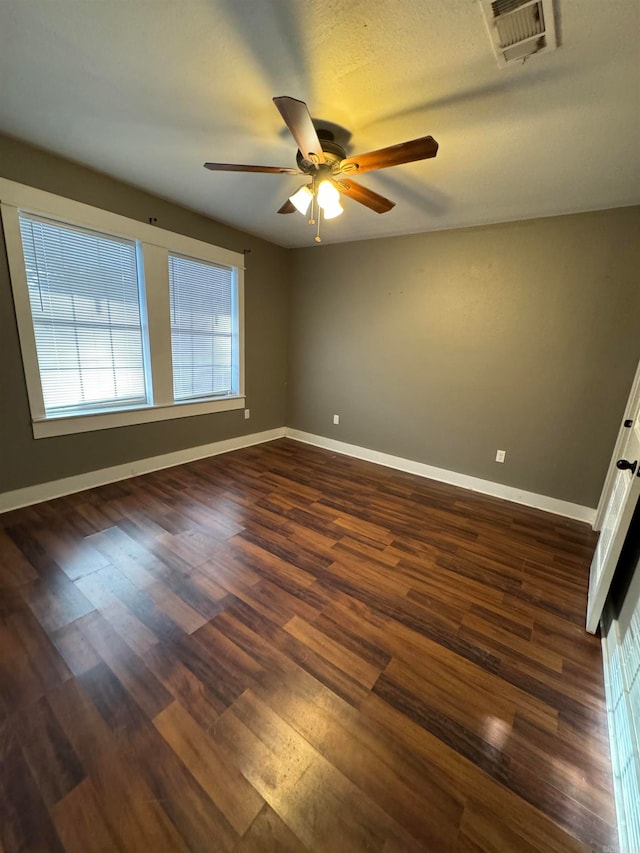 unfurnished room featuring dark hardwood / wood-style floors and ceiling fan