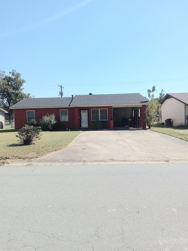 ranch-style house with a front lawn and a carport