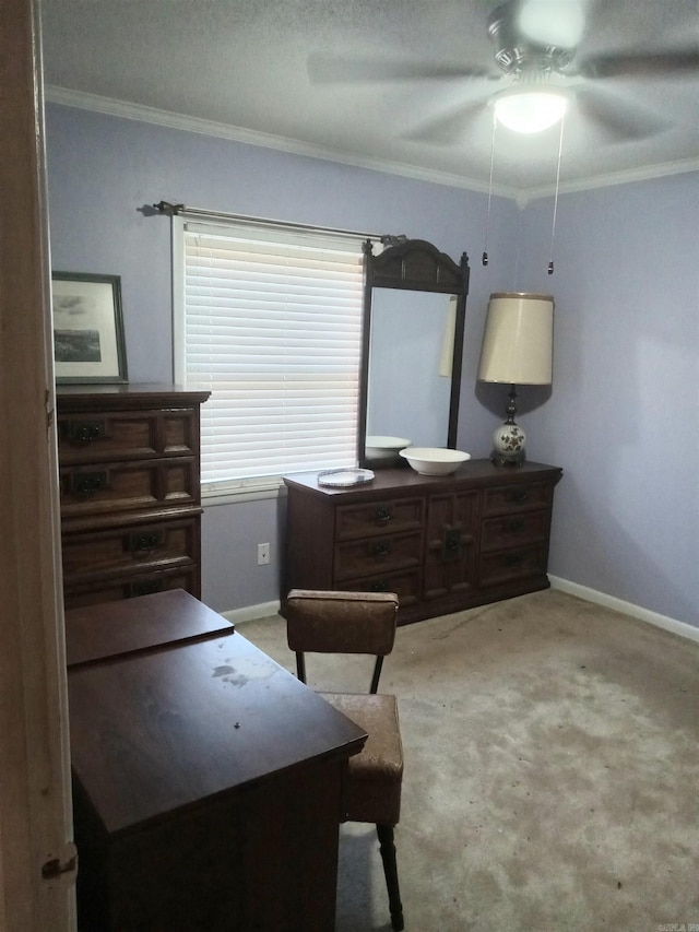 carpeted bedroom featuring ceiling fan, ornamental molding, and a textured ceiling