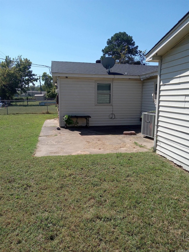 exterior space with a yard, a patio area, and central AC