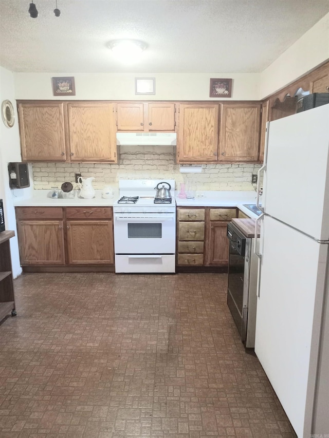 kitchen featuring decorative backsplash, a textured ceiling, and white appliances