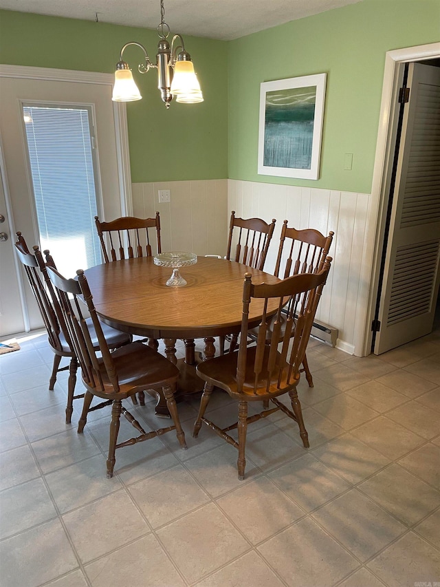 dining room with light tile patterned floors and a chandelier