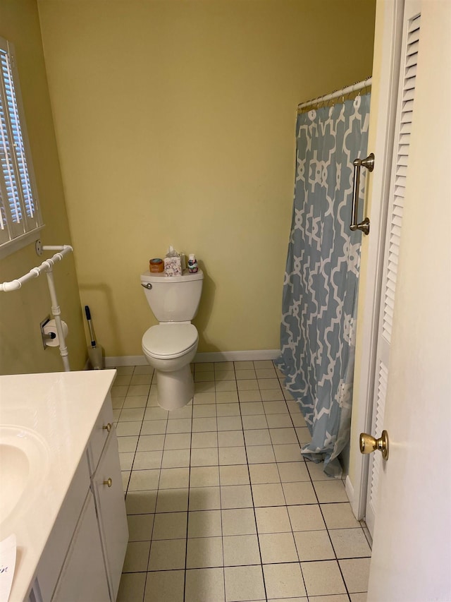 bathroom featuring tile patterned floors, vanity, and toilet