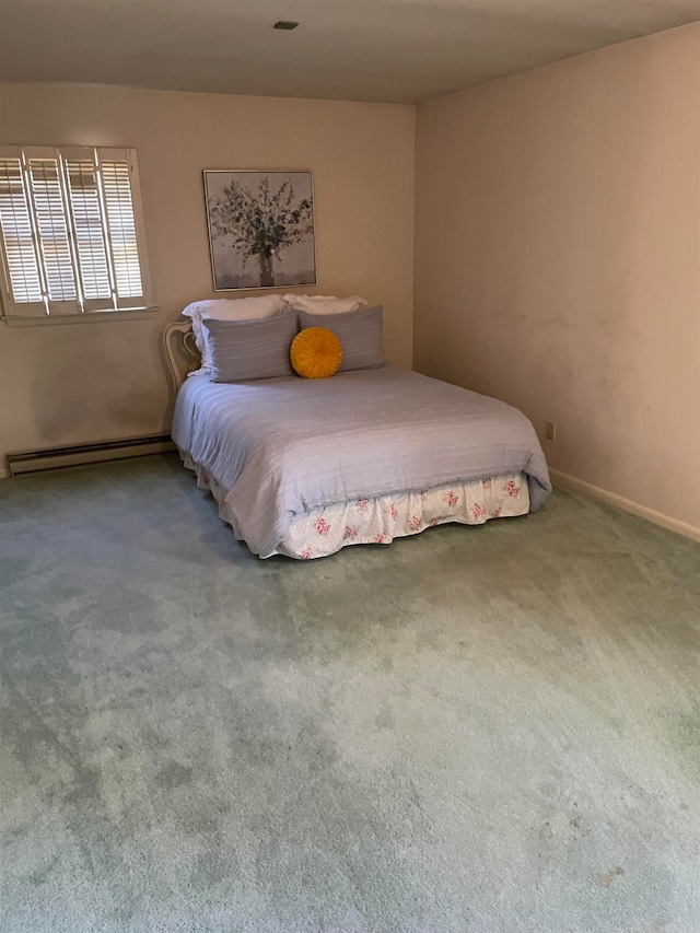 carpeted bedroom featuring a baseboard heating unit