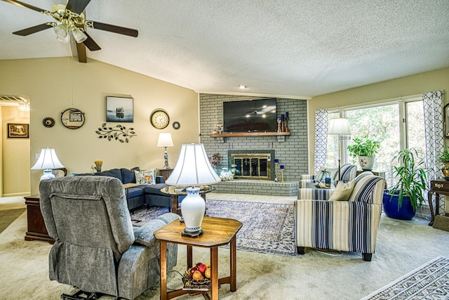 carpeted living room featuring ceiling fan, vaulted ceiling with beams, a textured ceiling, and a brick fireplace