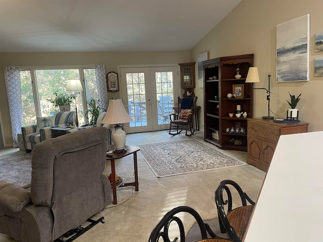 carpeted living room featuring french doors, vaulted ceiling, and plenty of natural light