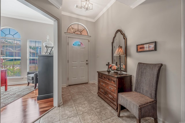 entryway featuring ornamental molding and light wood-type flooring