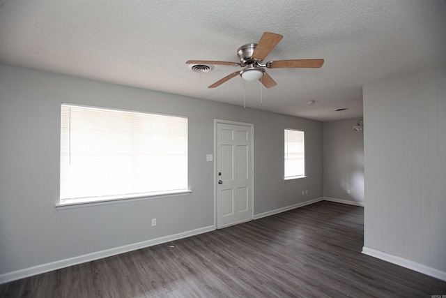 interior space featuring dark hardwood / wood-style floors, a textured ceiling, and ceiling fan