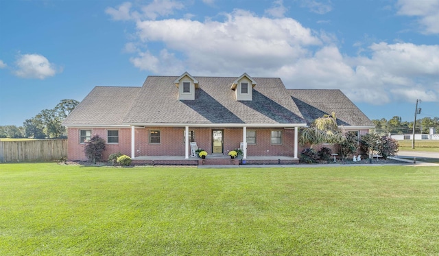 view of front of house featuring a front lawn and covered porch