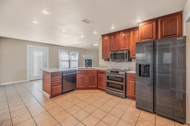 kitchen with light stone countertops, light tile patterned flooring, kitchen peninsula, ceiling fan, and stainless steel appliances