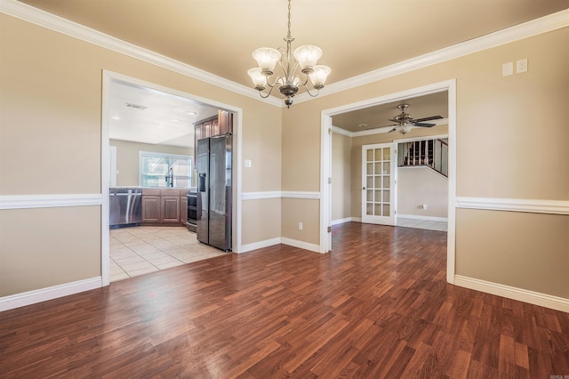 unfurnished dining area featuring light hardwood / wood-style floors, crown molding, and ceiling fan with notable chandelier