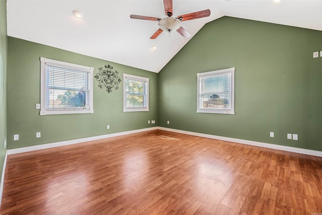 unfurnished room with lofted ceiling, hardwood / wood-style floors, and ceiling fan