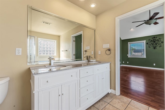 bathroom with vanity, toilet, ceiling fan, and hardwood / wood-style floors