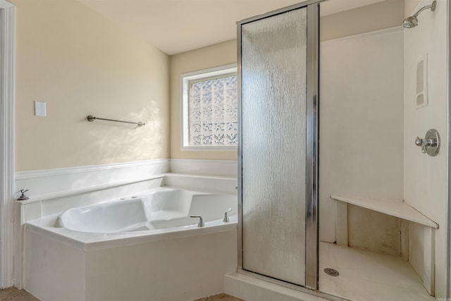 bathroom featuring plus walk in shower and tile patterned flooring