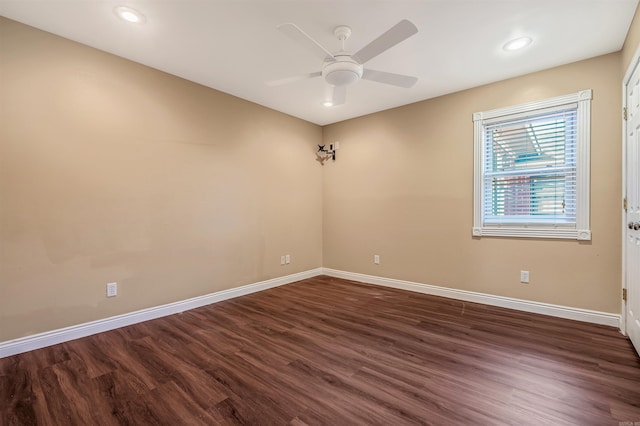 unfurnished room featuring dark wood-type flooring and ceiling fan