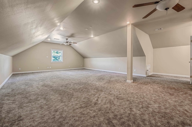 additional living space featuring ceiling fan, a textured ceiling, carpet, and lofted ceiling