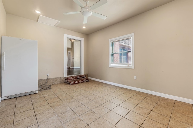 spare room with light tile patterned floors and ceiling fan