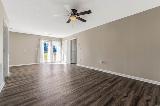 spare room featuring dark hardwood / wood-style floors, a textured ceiling, and ceiling fan