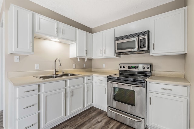 kitchen featuring white cabinetry, stainless steel appliances, sink, and dark hardwood / wood-style flooring