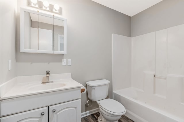 full bathroom with vanity, hardwood / wood-style floors, bathing tub / shower combination, and toilet