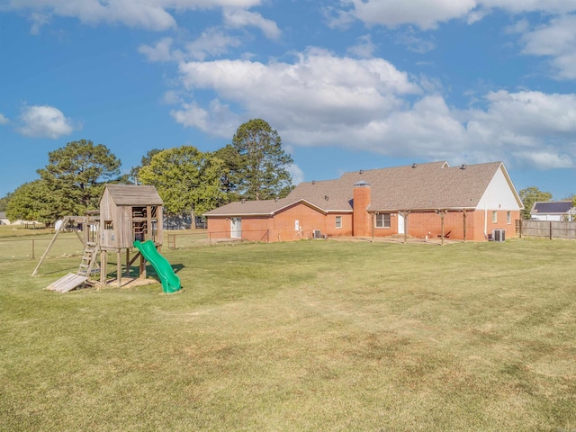 view of yard with central AC and a playground