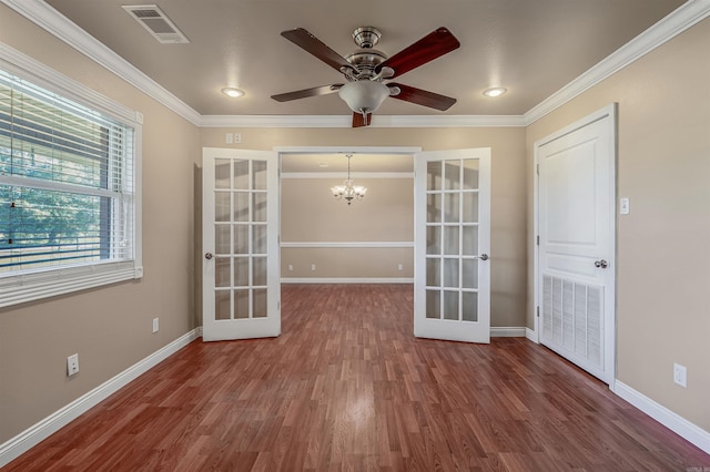 unfurnished room featuring french doors, ornamental molding, hardwood / wood-style flooring, and ceiling fan with notable chandelier