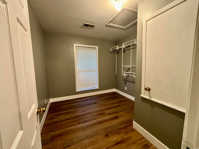 spacious closet with dark wood-type flooring