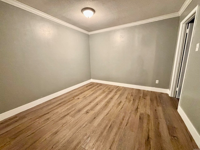 unfurnished room featuring crown molding, a textured ceiling, and hardwood / wood-style floors