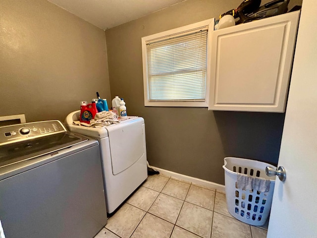 washroom featuring cabinets, independent washer and dryer, and light tile patterned floors