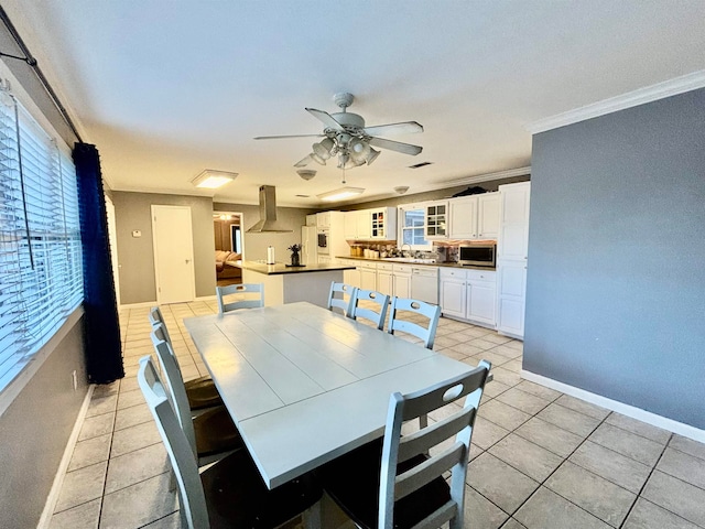 tiled dining room featuring ornamental molding, a healthy amount of sunlight, and ceiling fan