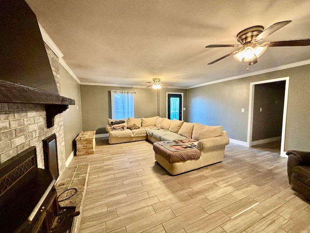 living room featuring ceiling fan, crown molding, light hardwood / wood-style flooring, and a brick fireplace