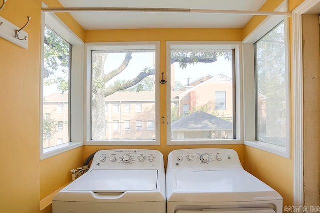 clothes washing area featuring separate washer and dryer