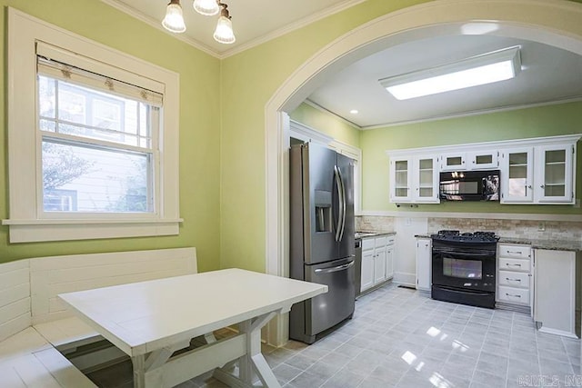 kitchen featuring white cabinetry, crown molding, tasteful backsplash, a chandelier, and black appliances