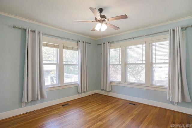 spare room with crown molding, ceiling fan, and hardwood / wood-style flooring