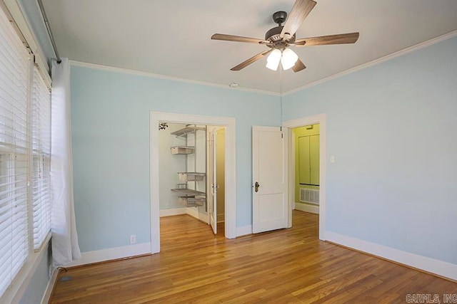 unfurnished bedroom with crown molding, ceiling fan, and light hardwood / wood-style flooring