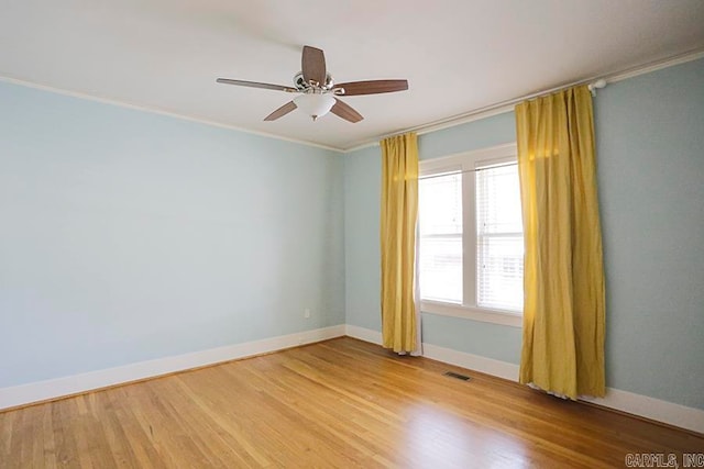 unfurnished room with hardwood / wood-style flooring, crown molding, and ceiling fan