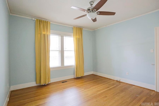 empty room featuring ceiling fan, ornamental molding, and light wood-type flooring