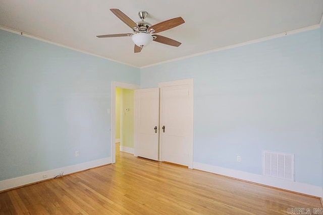 unfurnished room featuring ornamental molding, ceiling fan, and light wood-type flooring