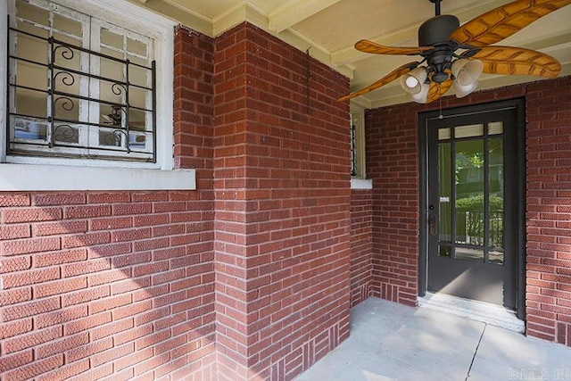 entrance to property with ceiling fan