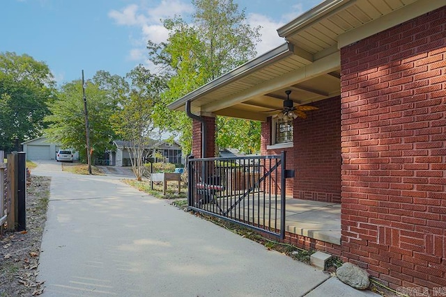 view of patio / terrace featuring ceiling fan and a garage