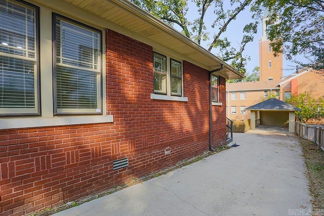 view of property exterior with a garage and an outdoor structure