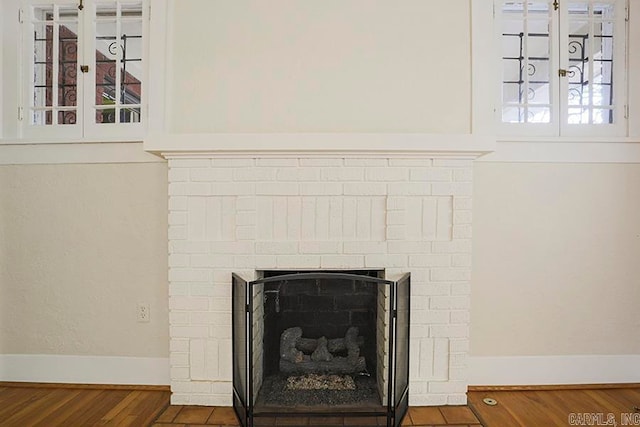 details featuring hardwood / wood-style flooring and a fireplace